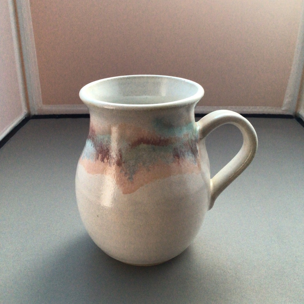 Handmade pottery vessel with traditional design and handle, signed "Johann"